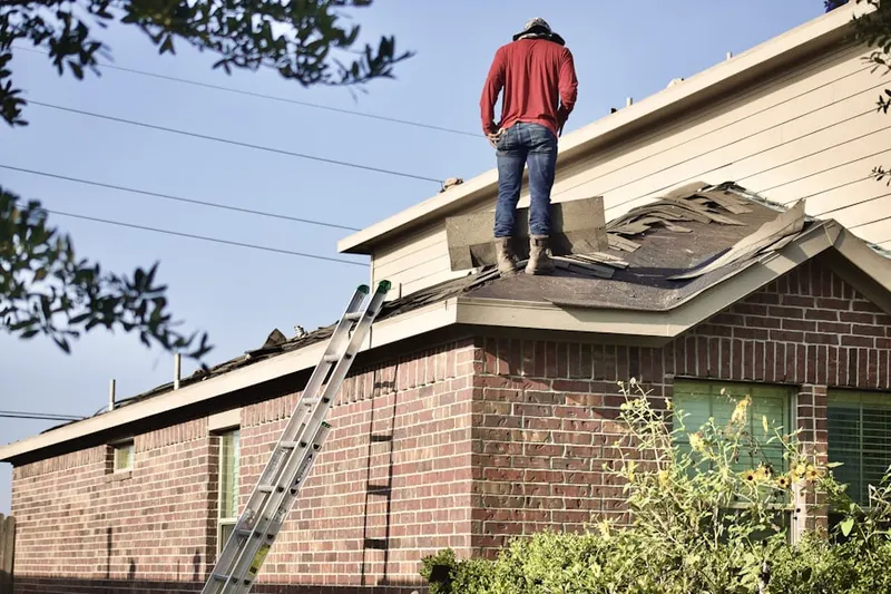 Professional roofer working on a residential roof in Pike Creek Valley